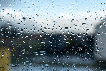 Raindrops on the window and a blurred background 