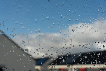 Raindrops on the window and a blurred background 