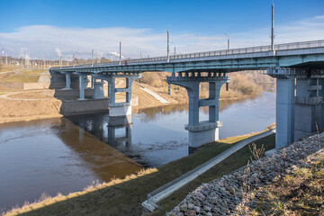 steel frame and concrete construction huge car bridge across the wide river.