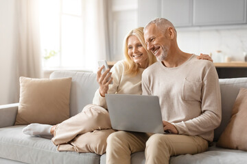 Mature couple enjoying technology together