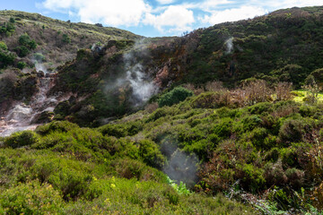 Naklejka na ściany i meble Surreal landscape of sulfur fumaroles at Terceira Island, Azores. Captivating natural wonders amid volcanic terrain.