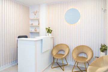 Reception of beautician clinic with counter and chairs
