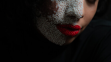 Close up of brunette model with bead fashion make up