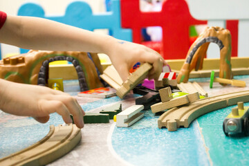 A child plays with a wooden road. children's toys. Eco-friendly toys