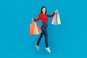Woman in Red Sweater Holding Shopping Bags