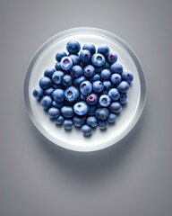 Blueberries in a soap bubble on a gray background