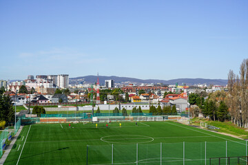 Beautiful Bratislava cityscape in early spring sunny morning with the soccer field in the foreground