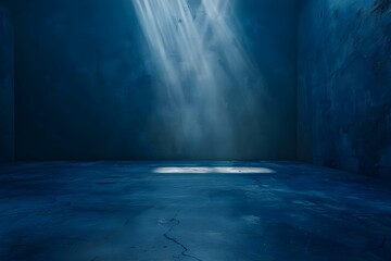 Empty dark blue room with concrete floor and spotlight ideal for dramatic or mysterious themed designs. Concept Dark Blue Room, Concrete Floor, Spotlight, Dramatic Design, Mysterious Theme - obrazy, fototapety, plakaty