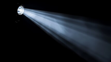 Bright white spotlight with a narrow beam in the dark.