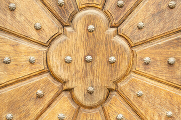 Wooden door panel with decorative rivets