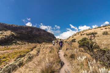 group of hikers walking through the paramo and rock formations of mountains of Los Nevados National Natural Park in Colombia