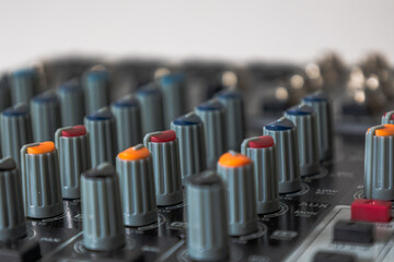 Potentiometers in different colours sound mixing console