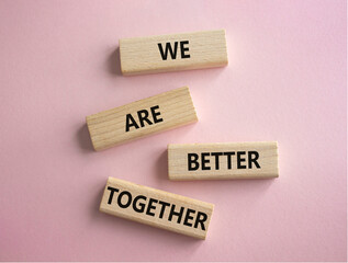 We are better together symbol. Wooden blocks with words We are better together. Beautiful pink background. We are better together concept. Copy space.