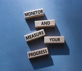 Monitor and Measure your Progress symbol. Wooden blocks with words Monitor and Measure your...