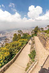 Viewpoint overlooking the landscape of the city of Bogota in Colombia from Monserrate Hill on a sunny summer day with clouds and some vegetation