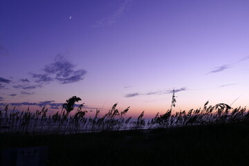 sunset and moon over the ocean
