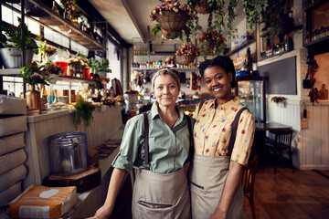 Portrait of two diverse waitresses in a rustic restaurant