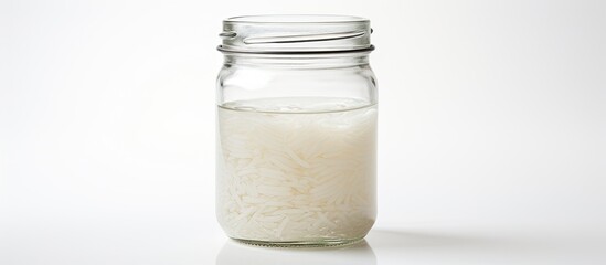 Transparent glass jar filled with clear liquid, showing a smooth reflective surface