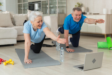 Fitness workout training. Senior adult mature healthy fit couple doing sports exercise on yoga mat on floor at home. Mid age old husband wife have training workout. Health care healthy lifestyle - obrazy, fototapety, plakaty