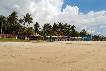 A sunny day on Olho D'água beach, São Luis island, state of Maranhão, northeast of Brazil, with no one, and the blue sky with white clouds in the background