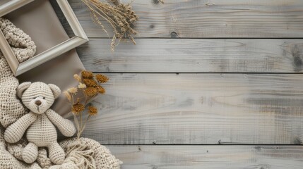 a modern minimalistic square wooden frame mockup on a light wood table, complemented by a teddy bear toy and baby blanket, all bathed in soft beige tones and warm lighting, captured from a top view.