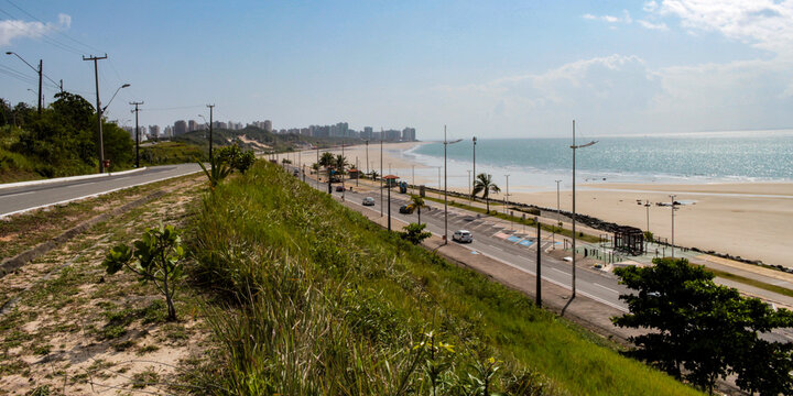Calhau beach, coastal avenue, dunes covered with vegetation and buildings on the horizon, on the island of São Luís, state of Maranhão, northeastern Brazil