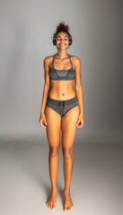Young African American woman in sportswear and headphones smiles and listens to music. Active lifestyle.