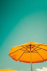 view from the bottom of bright beach umbrella and sky, retro colors