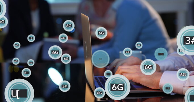 Image of 6g text and symbols in circles over cropped hands of caucasian man working on laptop - Powered by Adobe