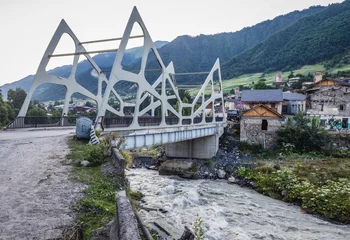 Fotobehang Bridge over Mestiachala River in Mestia town, Svanetia region, Georgia © Fotokon