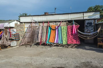 Fotobehang Hammocks and deckchairs for sale in roaside shop, Georgia © Fotokon