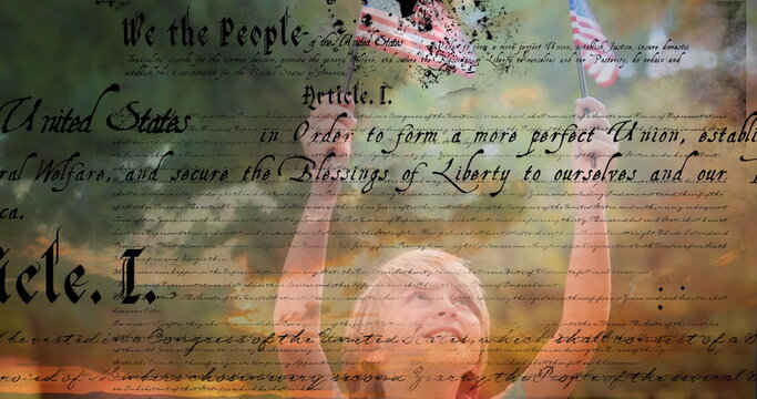 Digital composite of a Caucasian child holding out two American flags outdoors while a written const