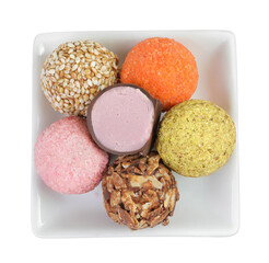 A variety of different truffles in a ceramic bowl Isolated on a white background. Top view. Flat lay