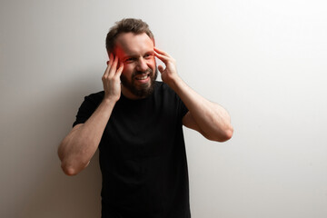 Head migraine chronic pain concept: middle aged bearded man holds his head in stress