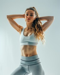 Fototapeta premium Attractive woman with a fashionable hairstyle in stylish sportswear. Fashion and beauty, active lifestyle and sports.