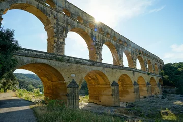 Foto op Plexiglas Pont du Gard Pont du Gard famous aqueduct bridge with three arched tiers, built in first century by Romans, popular tourist landmark, France