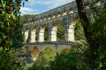 Papier Peint photo autocollant Pont du Gard Pont du Gard famous aqueduct bridge with three arched tiers, built in first century by Romans, popular tourist landmark, France