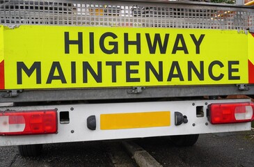 Highway maintenance sign of rear of works truck. road surface repairs and maintenance 