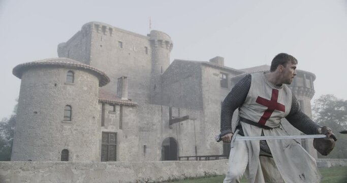 Cinematic knights templar battle in front of 14th century castle