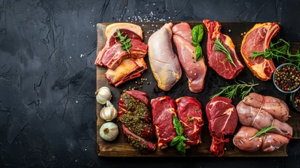 Fotobehang Different types of raw meat - beef, pork, lamb, chicken on dark background. Top view © Nijat