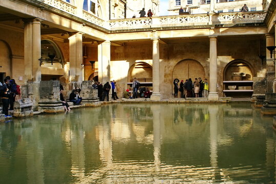 Tourists around a pool at the Roman Baths in Bath, England