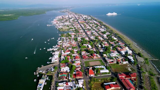 Drone footage showing Puntarenas city in Costa Rica at the pacific coast with boats in the ocean