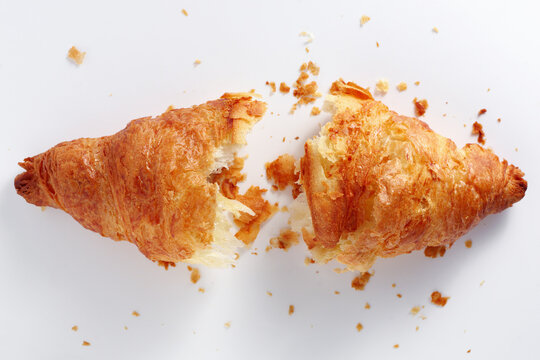 Broken croissant with crumbs