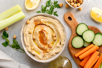 healthy snack fresh hummus with paprika with celery, carrots, cucumber, with chickpeas and olive oil, healthy lunch food