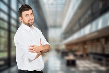Portrait of successful businessman in suit working inside office building