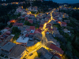 Aerial drone view of beautiful Karousades village by night in north corfu,Greece
