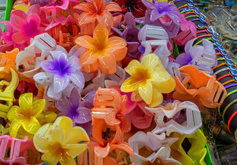 Large pile of cololrful plastic hair clips sold on outdoors market