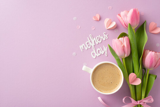 Mother's Day modern look: Top view photograph of cappuccino, fresh tulips, sentimental card, tiny hearts, and confetti on a gentle lilac background, leaving blank space for text or promotion