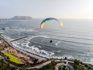 Paragliders in Miraflores, Lima, flies peacefully over the Miraflores boardwalk. It is possible to appreciate the Pacific Ocean, the Costa Verde, the buildings and the parks that border the cliff.