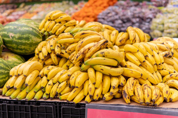 Group of bananas piled up on a supermarket hanger